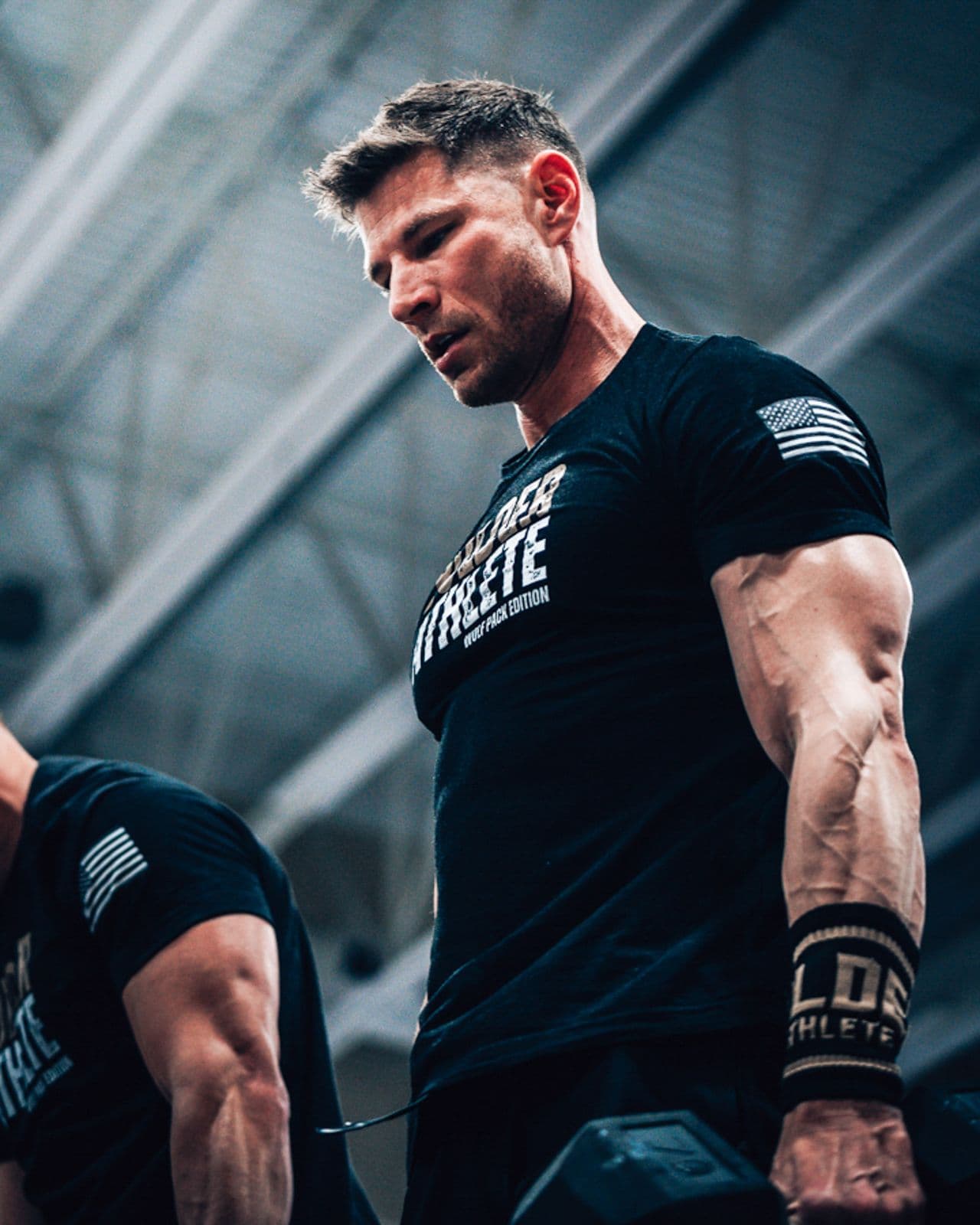 Athlete in a Bolder Athlete shirt focused between sets