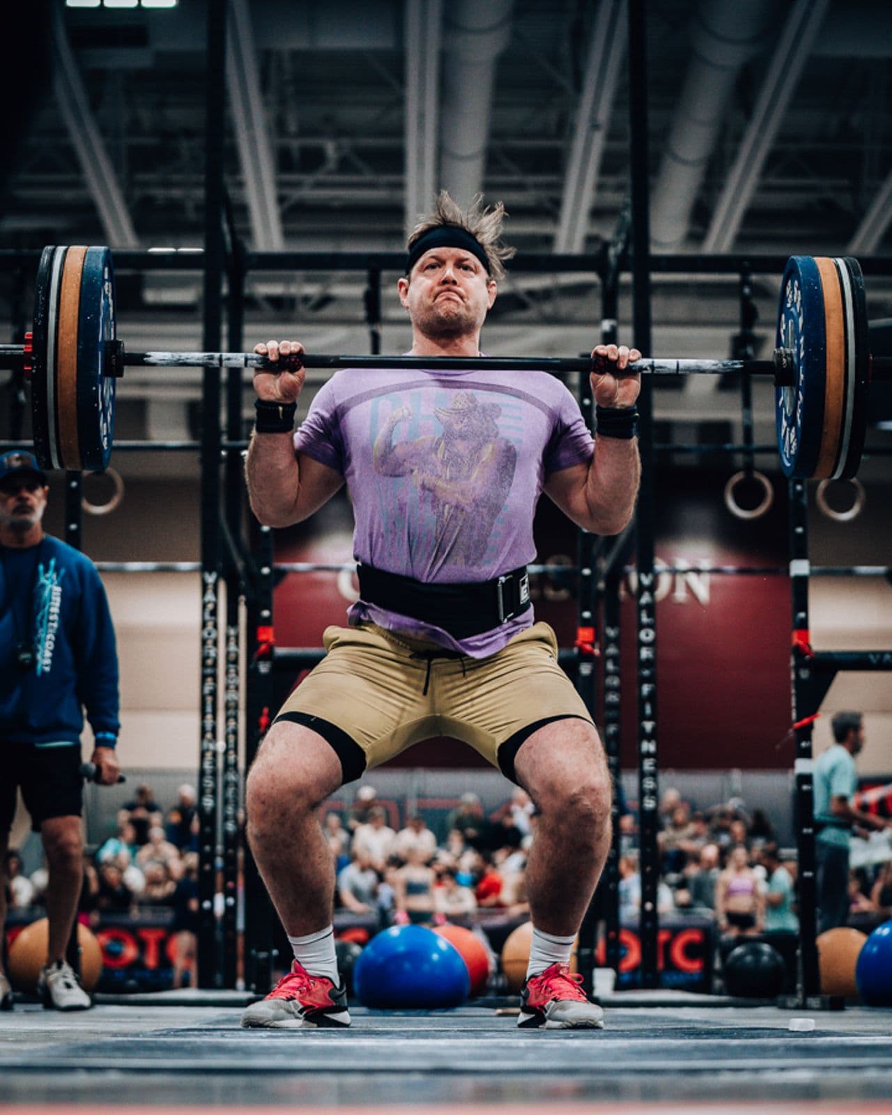Athlete front squatting in competition